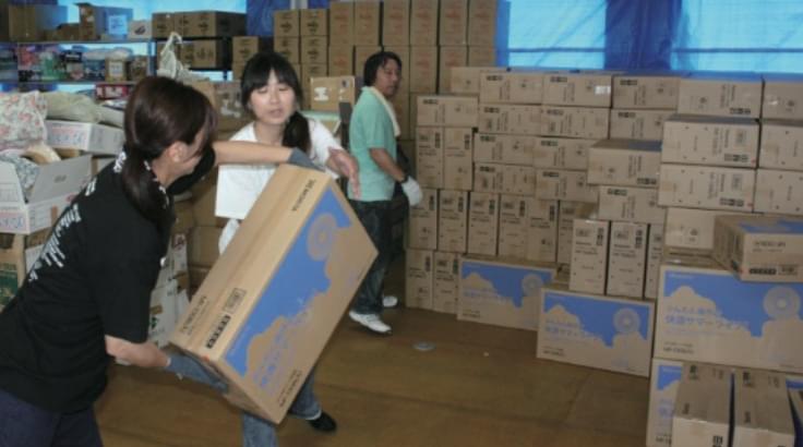 Electric fans being carried in their cardboard boxes